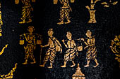 Wat Xieng Thong temple in Luang Prabang, Laos. Detail of the  intricate gold stencilling on black lacquer that decorate the walls of the sim. 